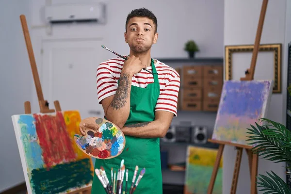 Brazilian Young Man Holding Painter Palette Artist Studio Puffing Cheeks —  Fotos de Stock