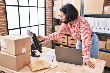 Young woman ecommerce business worker using laptop at office