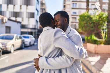 Man and woman couple hugging each other standing at street