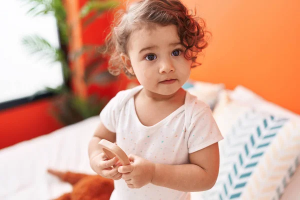 Adorable Hispanic Toddler Holding Toy Standing Bed Bedroom — Stock Photo, Image
