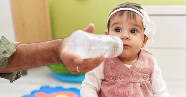 Urocze Latynoskie Dziecko Pijące Wodę Podłodze Domu — Zdjęcie stockowe
