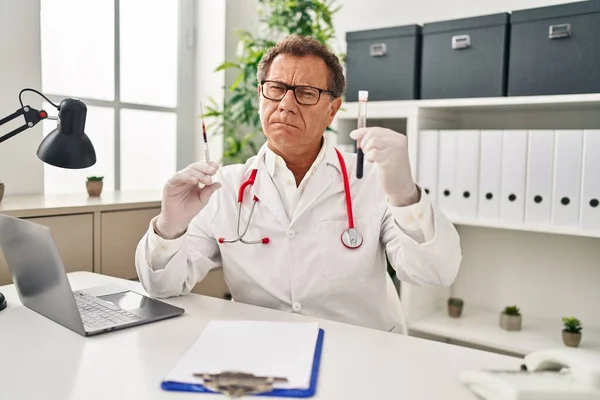 Senior Doctor Man Holding Syringe Blood Sample Skeptic Nervous Frowning — Stok fotoğraf