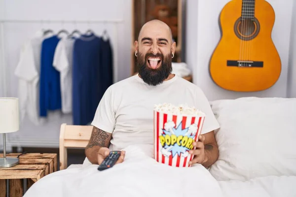 Young Hispanic Man Beard Tattoos Eating Popcorn Bed Sticking Tongue — Stock Photo, Image