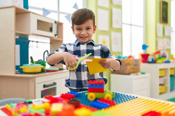 Adorable Hispanic Boy Student Smiling Confident Cutting Paper Kindergarten — Zdjęcie stockowe