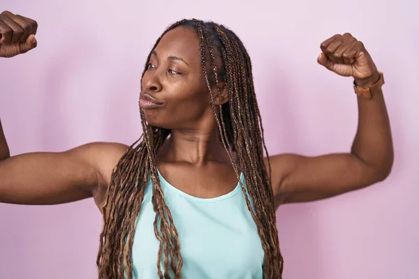 African American Woman Standing Pink Background Showing Arms Muscles Smiling — Stockfoto