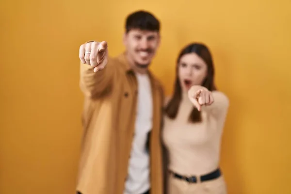 Young Hispanic Couple Standing Yellow Background Pointing Displeased Frustrated Camera — 图库照片
