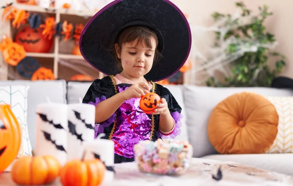 Adorable Hispanic Girl Having Halloween Party Putting Sweets Pumpkin Basket — Stok fotoğraf