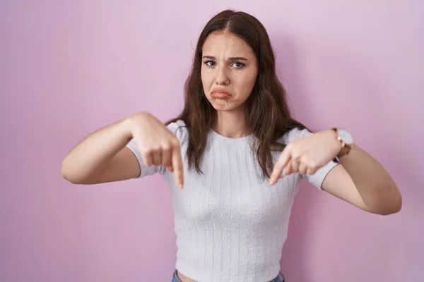 Young Hispanic Girl Standing Pink Background Pointing Looking Sad Upset — Foto Stock