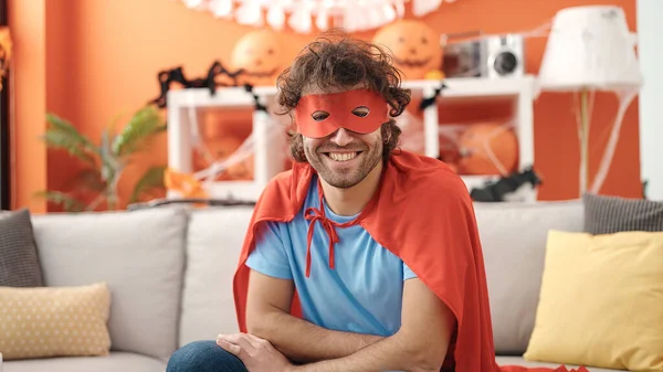 Young Hispanic Man Wearing Superhero Costume Having Halloween Party Home — стоковое фото