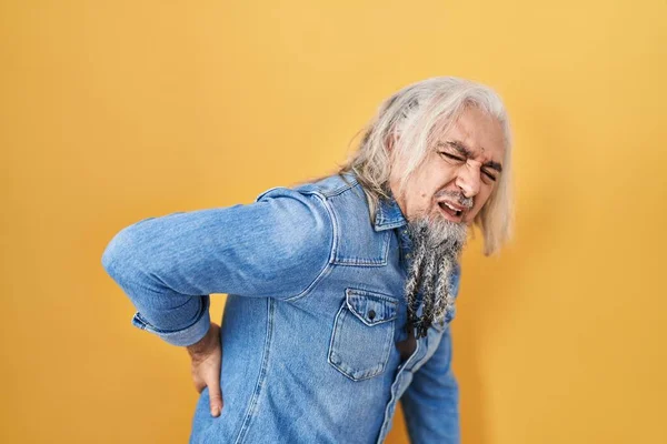 Beyaz Saçlı Orta Yaşlı Bir Adam Sarı Arka Planda Duruyor — Stok fotoğraf