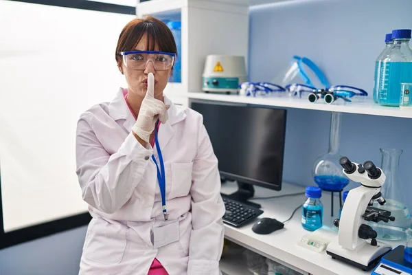 Young Brunette Woman Working Scientist Laboratory Asking Quiet Finger Lips — Stock Photo, Image