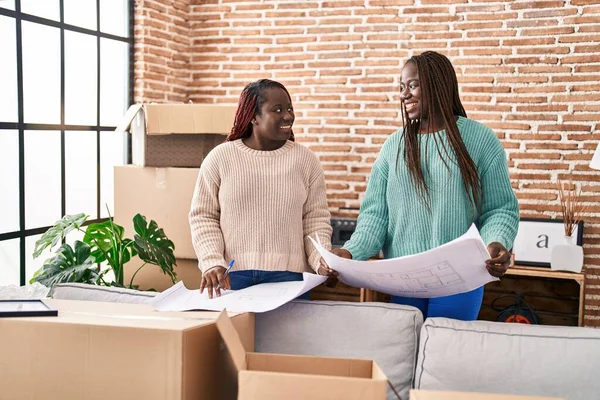 African American Women Smiling Confident Looking House Plans New Home — Stockfoto