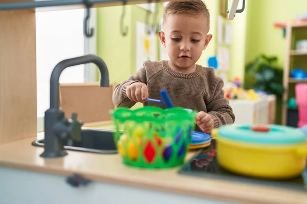 Adorable Hispanic Boy Playing Play Kitchen Standing Kindergarten — Fotografia de Stock