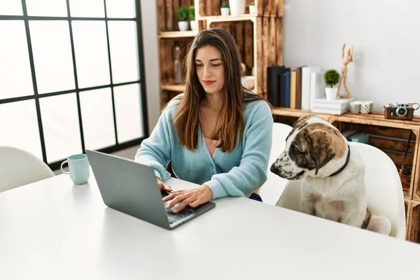 Evde Köpekle Aynı Masada Oturan Dizüstü Bilgisayar Kullanan Genç Bir — Stok fotoğraf