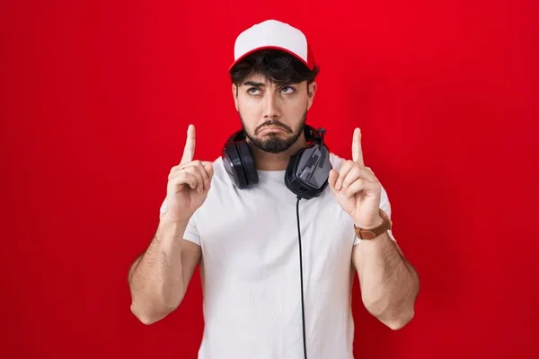 Hispanic Man Beard Wearing Gamer Hat Headphones Pointing Looking Sad — Stock Photo, Image