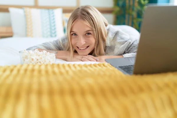 Young Blonde Woman Watching Movie Laptop Lying Bed Bedroom — Stockfoto
