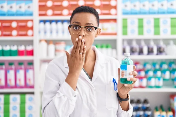 African American Woman Working Pharmacy Drugstore Holding Syrup Covering Mouth — Stockfoto