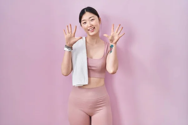Chinese Young Woman Wearing Sportswear Towel Showing Pointing Fingers Number — Zdjęcie stockowe
