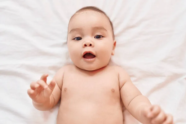 Sevimli Spanyol Bebek Yatakta Kendinden Emin Bir Şekilde Yatarken Gülümsüyor — Stok fotoğraf