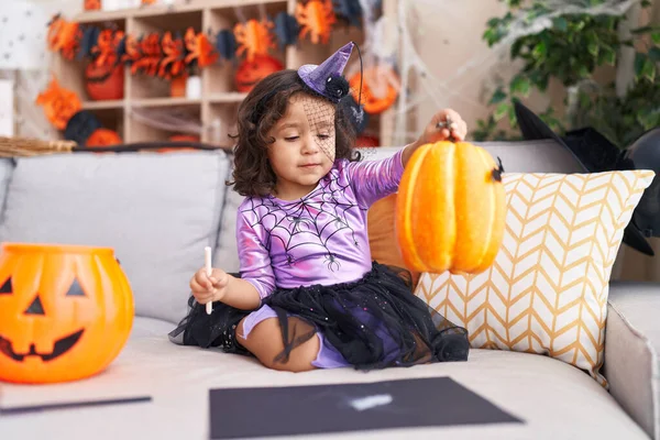 Adorable Hispanic Toddler Having Halloween Party Holding Pumpkin Toy Home — Foto de Stock