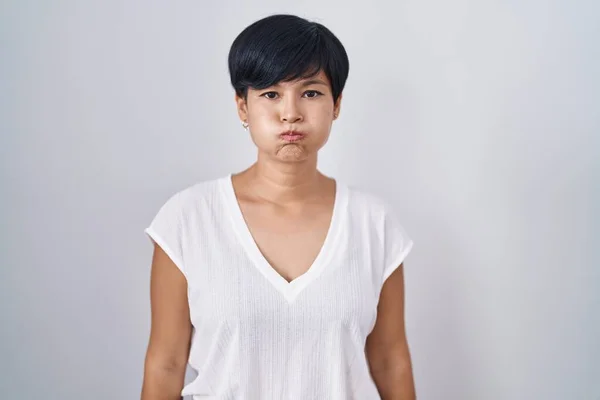 Young Asian Woman Short Hair Standing Isolated Background Puffing Cheeks — Stockfoto