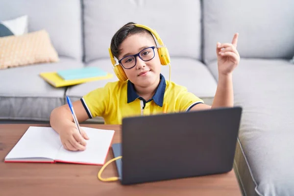 Young Hispanic Kid Doing Homework Laptop Home Smiling Happy Pointing — Stok fotoğraf