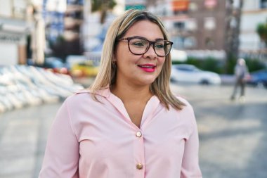 Sokakta kendine gülen genç İspanyol kadın.