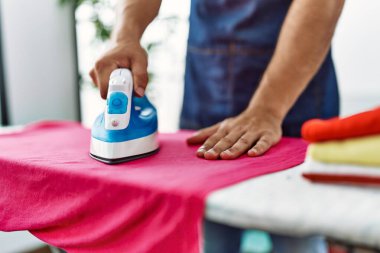 Evde ütü yapan genç bir İspanyol.