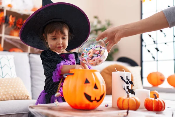 Adorable Hispanic Girl Having Halloween Party Putting Sweets Pumpkin Basket — Foto de Stock