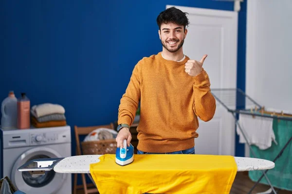 Hispanic Man Beard Ironing Clothes Home Smiling Happy Positive Thumb — Stok fotoğraf
