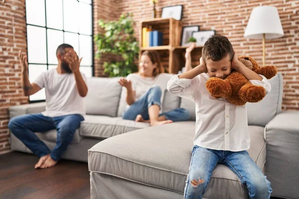 Family sitting on sofa and kid sad for partents argue at home