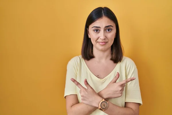 Hispanic Girl Wearing Casual Shirt Yellow Background Pointing Both Sides — Stock Photo, Image
