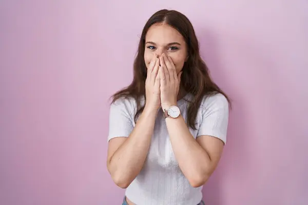 Young Hispanic Girl Standing Pink Background Laughing Embarrassed Giggle Covering — ストック写真