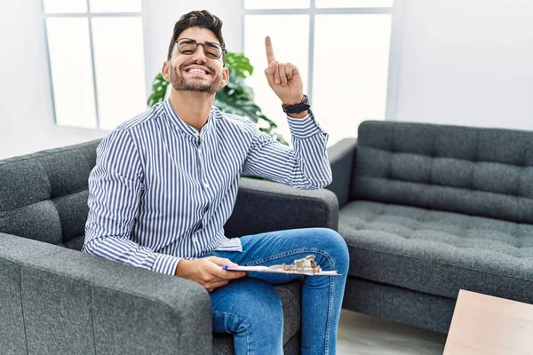 Young Psychologist Man Consultation Office Smiling Amazed Surprised Pointing Fingers — Stockfoto
