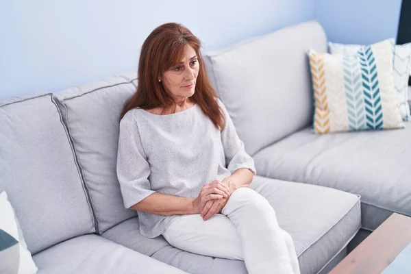 Middle Age Woman Sitting Sofa Serious Expression Home — Stock Photo, Image