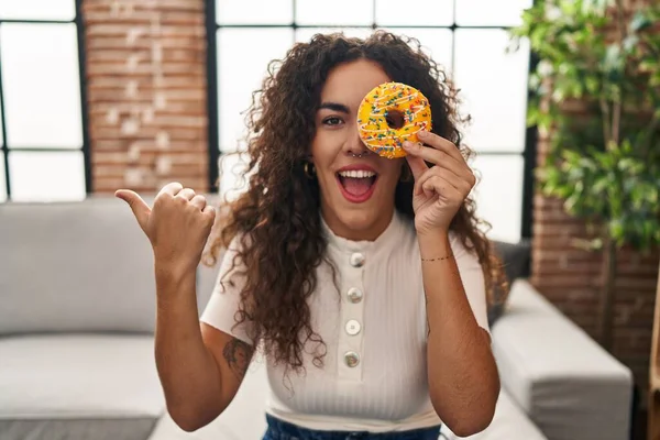 Young Hispanic Woman Holding Tasty Colorful Doughnut Eye Pointing Thumb — Photo