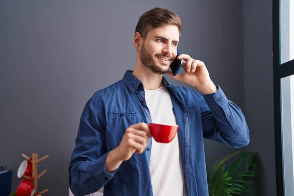 Young Caucasian Man Talking Smartphone Drinking Coffee Home — Stockfoto