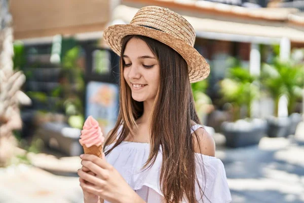 Adorable girl tourist smiling confident eating ice cream at street
