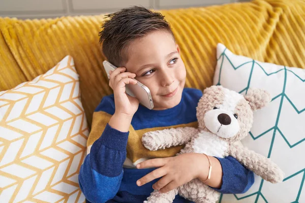 Adorable Hispanic Boy Hugging Teddy Bear Talking Smartphone Home — Stok fotoğraf
