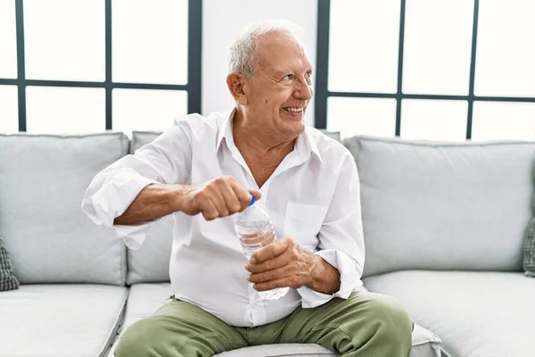 Uomo Anziano Che Beve Bottiglia Acqua Seduta Sul Divano Casa — Foto Stock