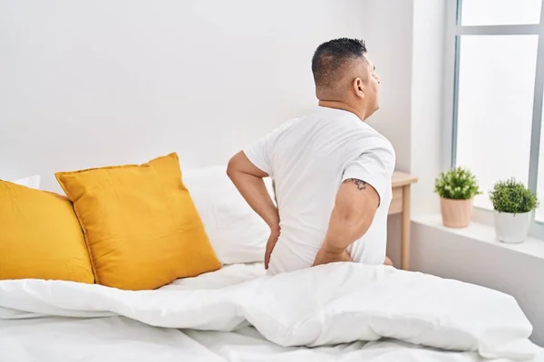 Young Latin Man Suffering Back Injury Sitting Bed Bedroom — Stockfoto