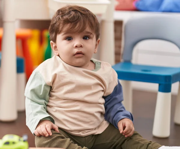 Adorable Hispanic Toddler Sitting Floor Serious Expression Playing Home — Stock Photo, Image