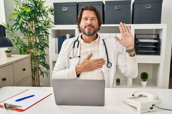 Handsome Middle Age Doctor Man Working Clinic Swearing Hand Chest — Stockfoto