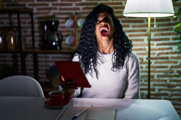 Middle Age Hispanic Woman Using Touchpad Sitting Table Night Angry — kuvapankkivalokuva