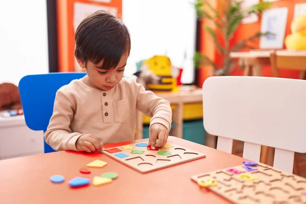 Adorable Hispanic Boy Playing Maths Puzzle Game Sitting Table Kindergarten — Fotografia de Stock