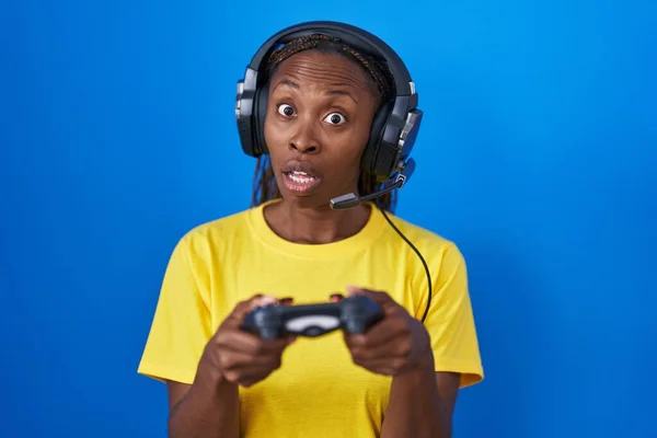 African American Woman Playing Video Games Shock Face Looking Skeptical — Stockfoto