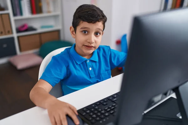 Adorable Hispanic Boy Student Using Computer Sitting Table Classroom —  Fotos de Stock