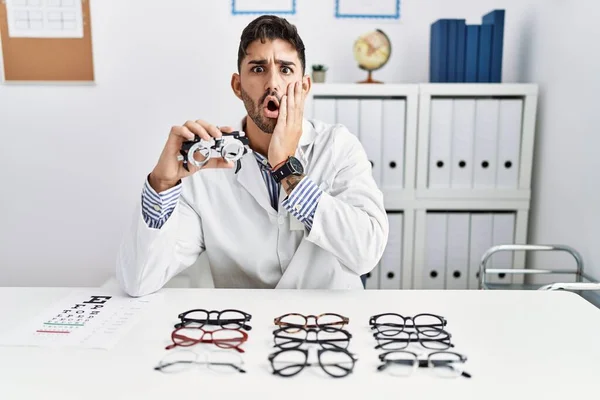 Young Optician Man Holding Optometry Glasses Afraid Shocked Surprise Amazed — 图库照片