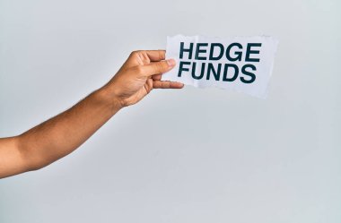 Hand of caucasian man holding paper with hedge funds message over isolated white background