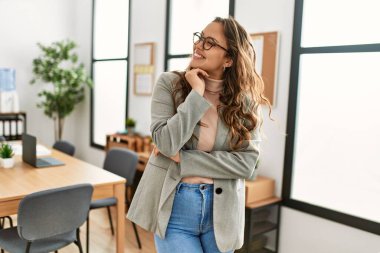 Genç, güzel, İspanyol bir iş adamı. Kendine güler yüzlü. Ofiste kollarını kavuşturmuş duruyor.